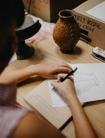person writing on white paper