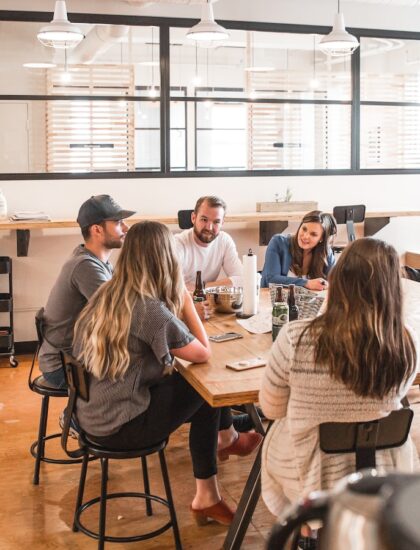 talking people sitting beside table